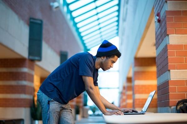 GVSU student working on his computer in Henry Hall